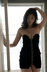 福士聖莉嘩女士穿著非常性感的深藍色連衣裙，她在窗邊，她是日本『時裝美女模特兒・寫真女優・自由播音員・電視藝人・藥劑師』，她的胸圍是87厘米，她具有迷人的『巨乳・美胸』，她是有性魅力的女性。